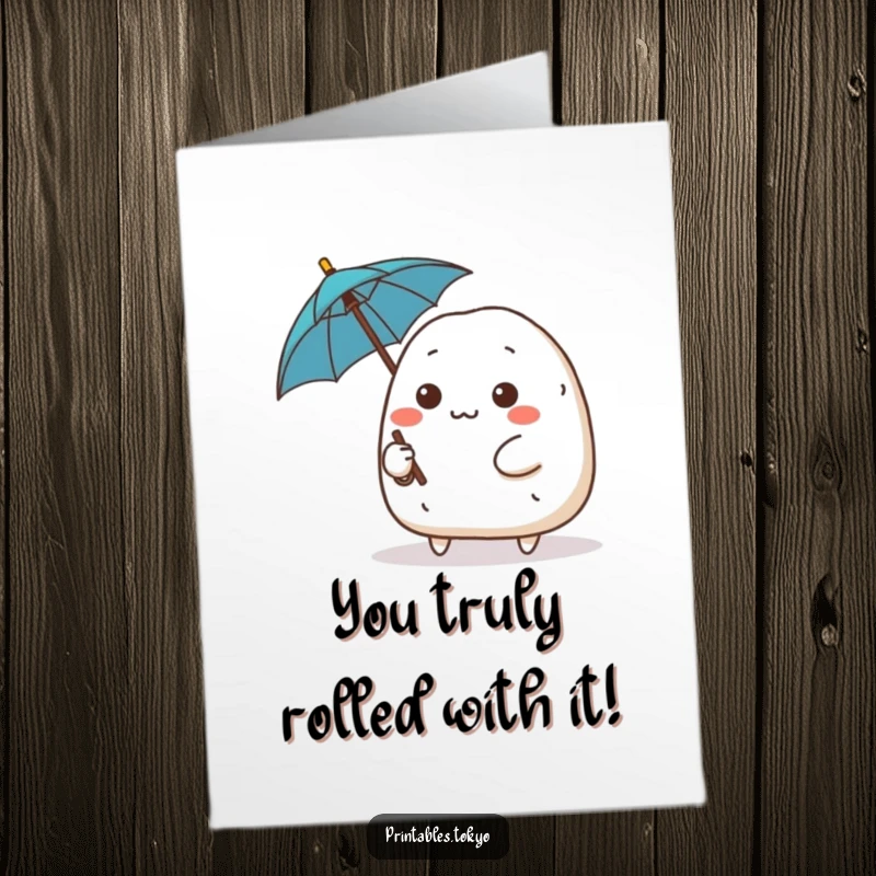 Funny Free Printable Congratulations Card showing a determined onigiri character ready with a tiny umbrella.