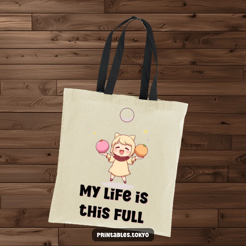 Funny tote bag featuring a character playfully juggling three colorful mochi balls, perfect for carrying items.